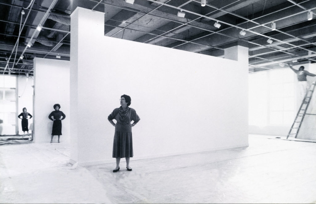 Archival black and white image of Rena Bransten Gallery staff in empty gallery space