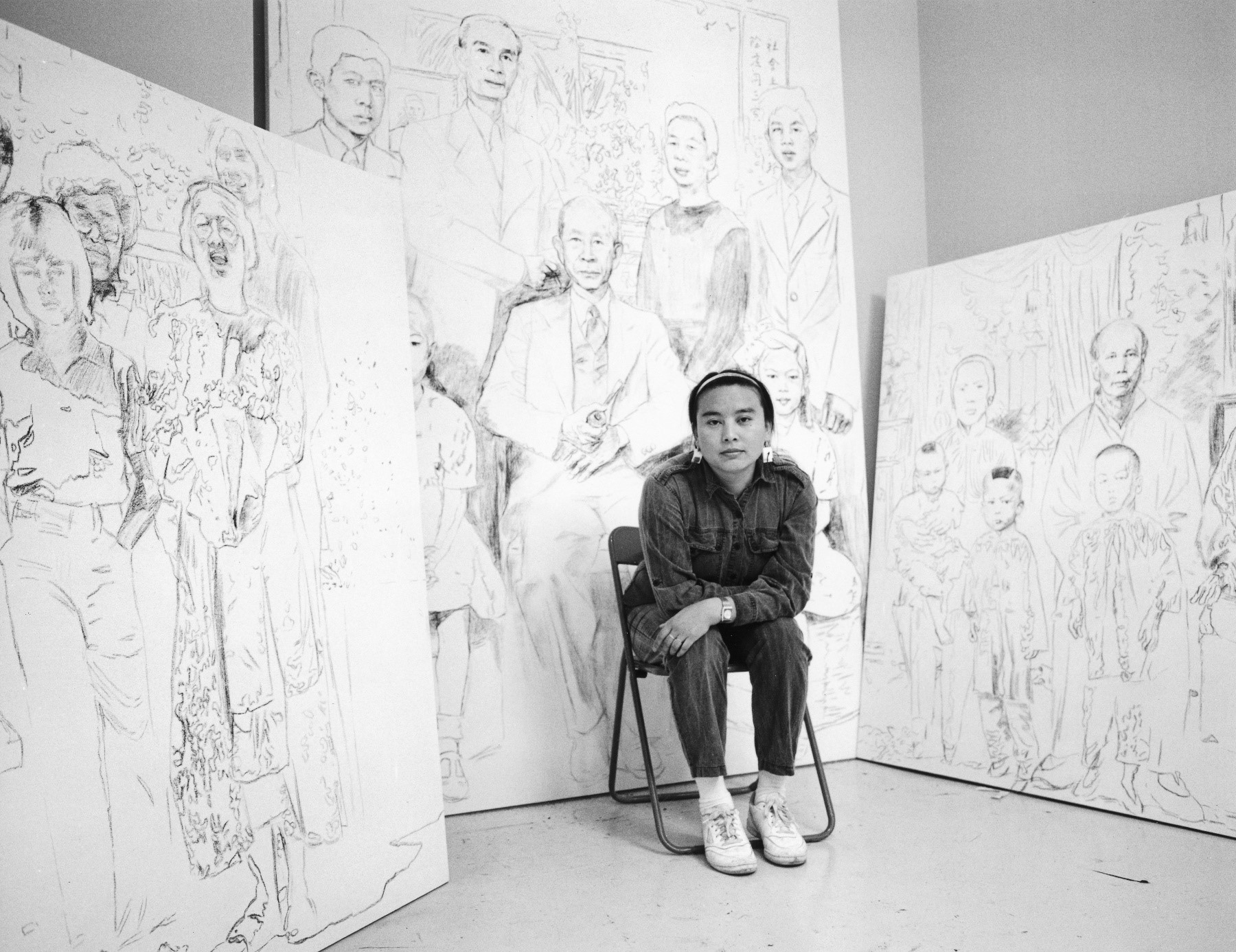 Archival black and white portrait of artist Hung Liu in front of her work
