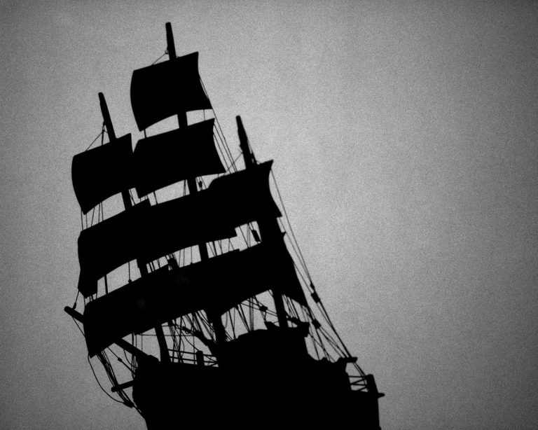 Silhouette of a large ship in black and white