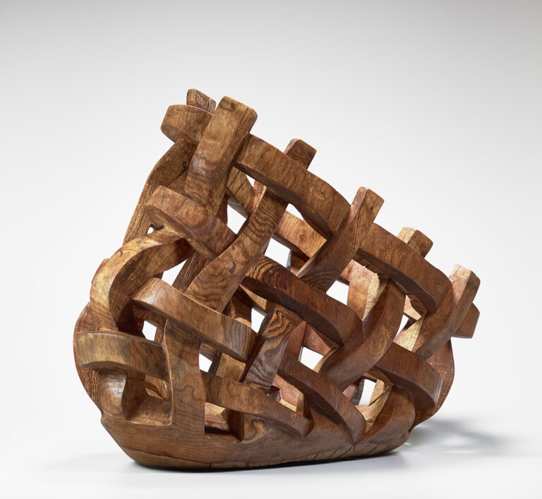 Wooden sculpture in woven basket shape, by Sam Perry